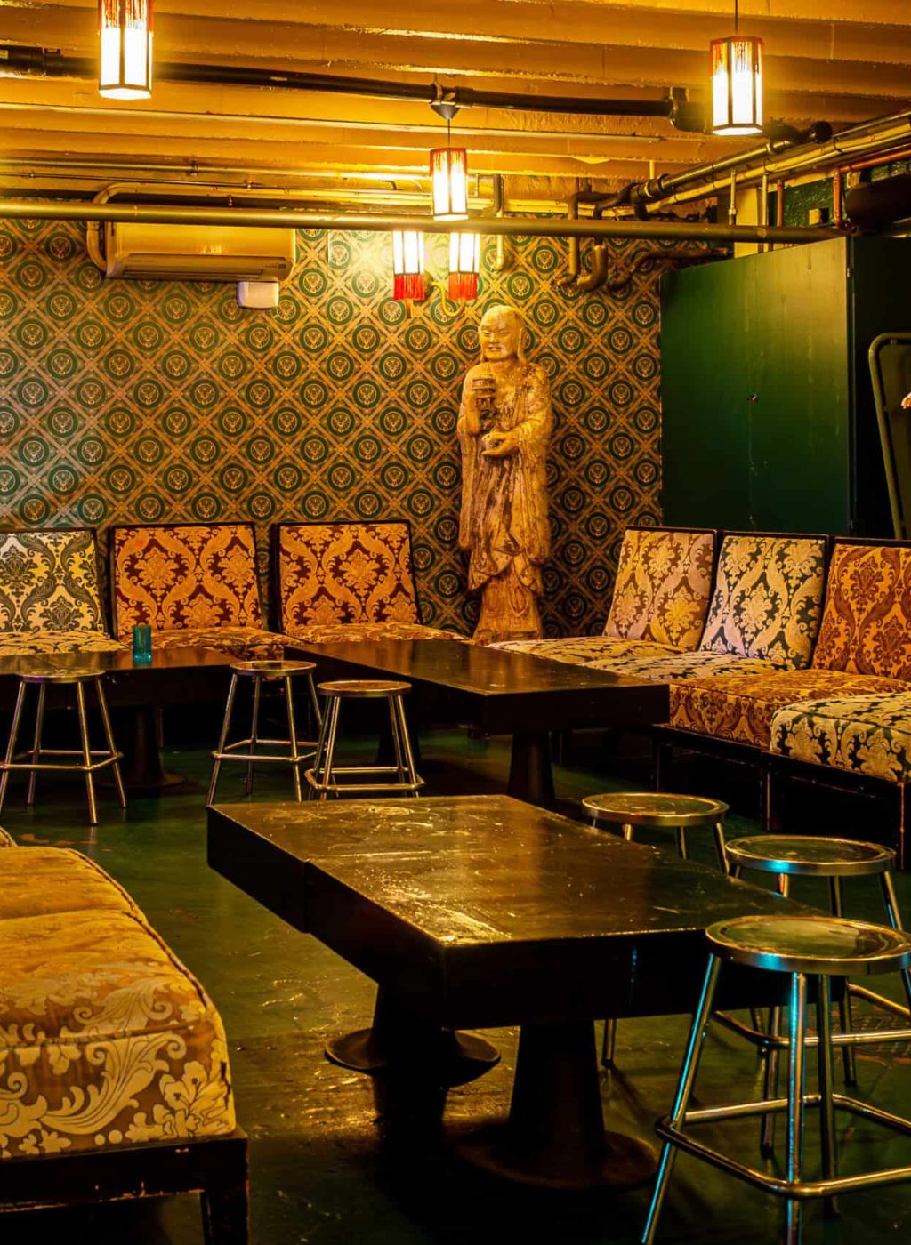 Intimate private lounge with vintage decor and plush seating at Scandale.